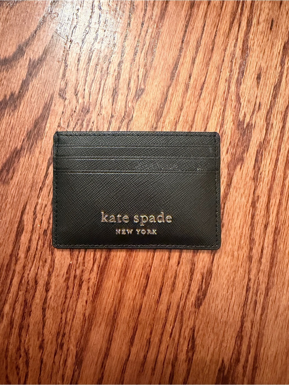 kate spade black card case with gold logo